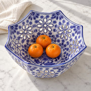 AI-assisted concept image of cobalt octagonal openwork fruit bowl: styled table view; food and props are not included.