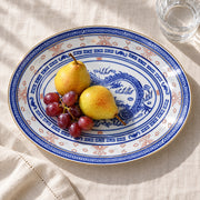 AI-assisted concept image of dragon & rice-grain oval platter: styled setting view; food and props are not included.