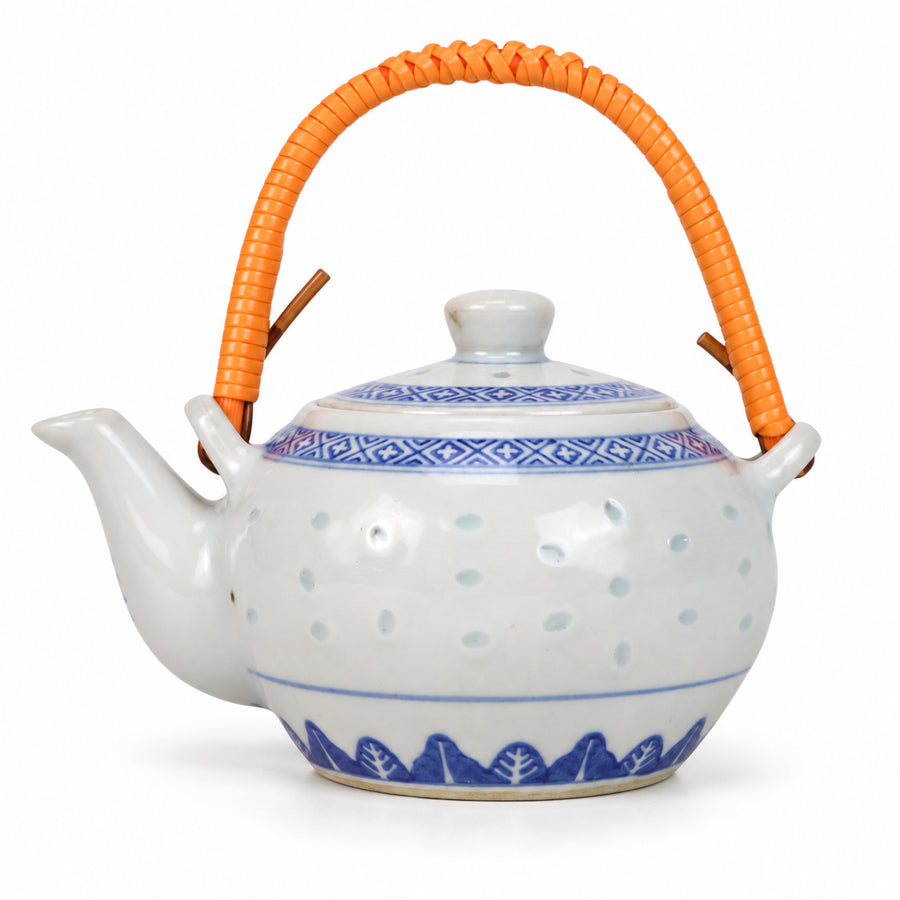 AI-assisted concept image of rice-grain teapot — orange handle: overall product view.