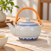 AI-assisted concept image of rice-grain teapot — orange handle: styled table view; food and props are not included.