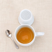 AI-assisted concept image of linglong landscape infuser mug: styled setting view; food and props are not included.