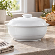AI-assisted concept image of sweet white lidded tureen: styled editorial view; food and props are not included.