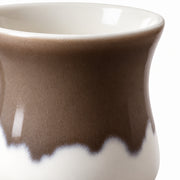 AI-assisted concept image of cocoa & cream handleless cup: detail of the surface and outline.