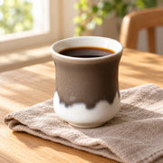 AI-assisted concept image of cocoa & cream handleless cup: styled table view; food and props are not included.