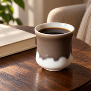 AI-assisted concept image of cocoa & cream handleless cup: styled setting view; food and props are not included.