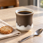 AI-assisted concept image of cocoa & cream handleless cup: styled editorial view; food and props are not included.