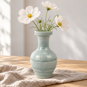 AI-assisted concept image of pale green ring-neck vase: styled table view; food and props are not included.