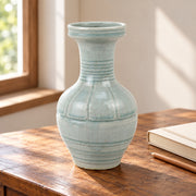 AI-assisted concept image of pale green ring-neck vase: styled setting view; food and props are not included.